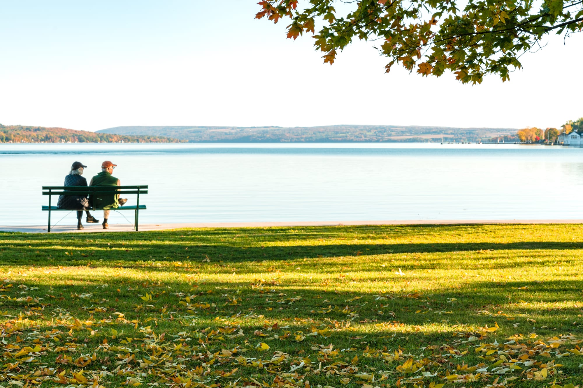 Couple sitting on bench viewing Skaneateles Lake in Finger Lakes area