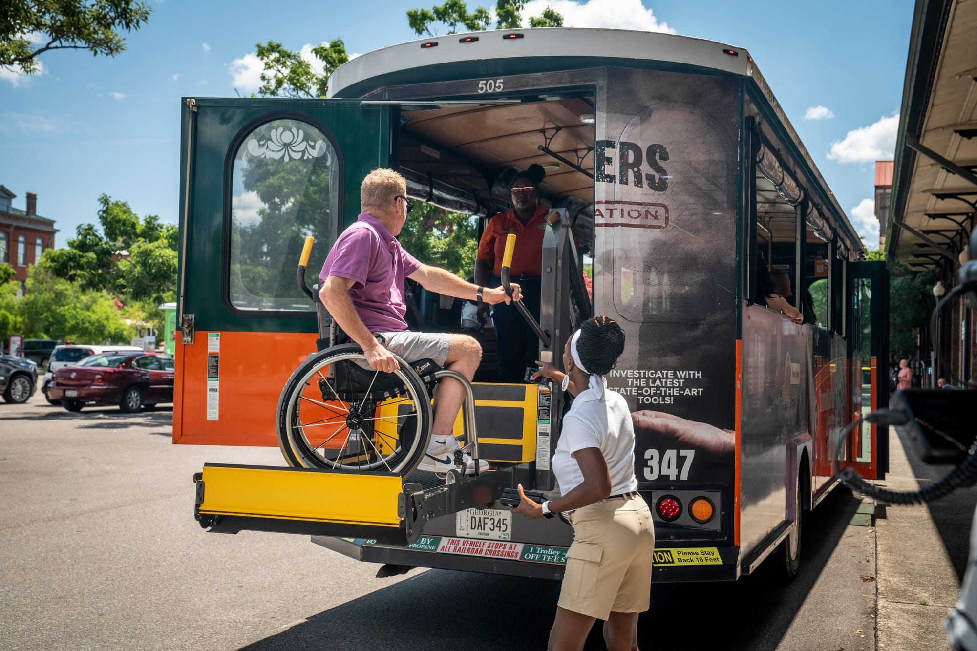 Wheelchair user entering an Old Town Trolley via lift, Savannah