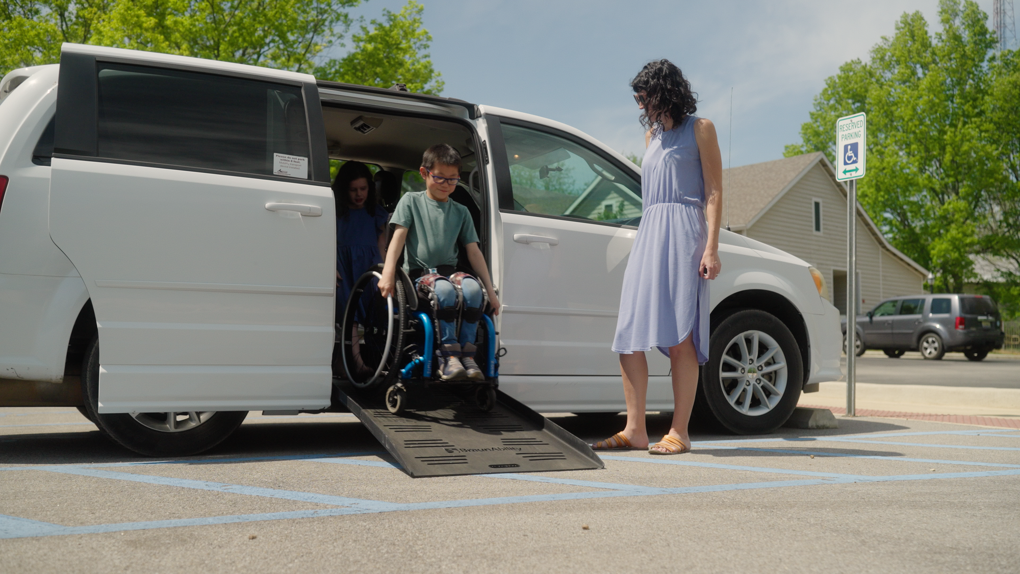 Wheelchair user exiting van via ramp