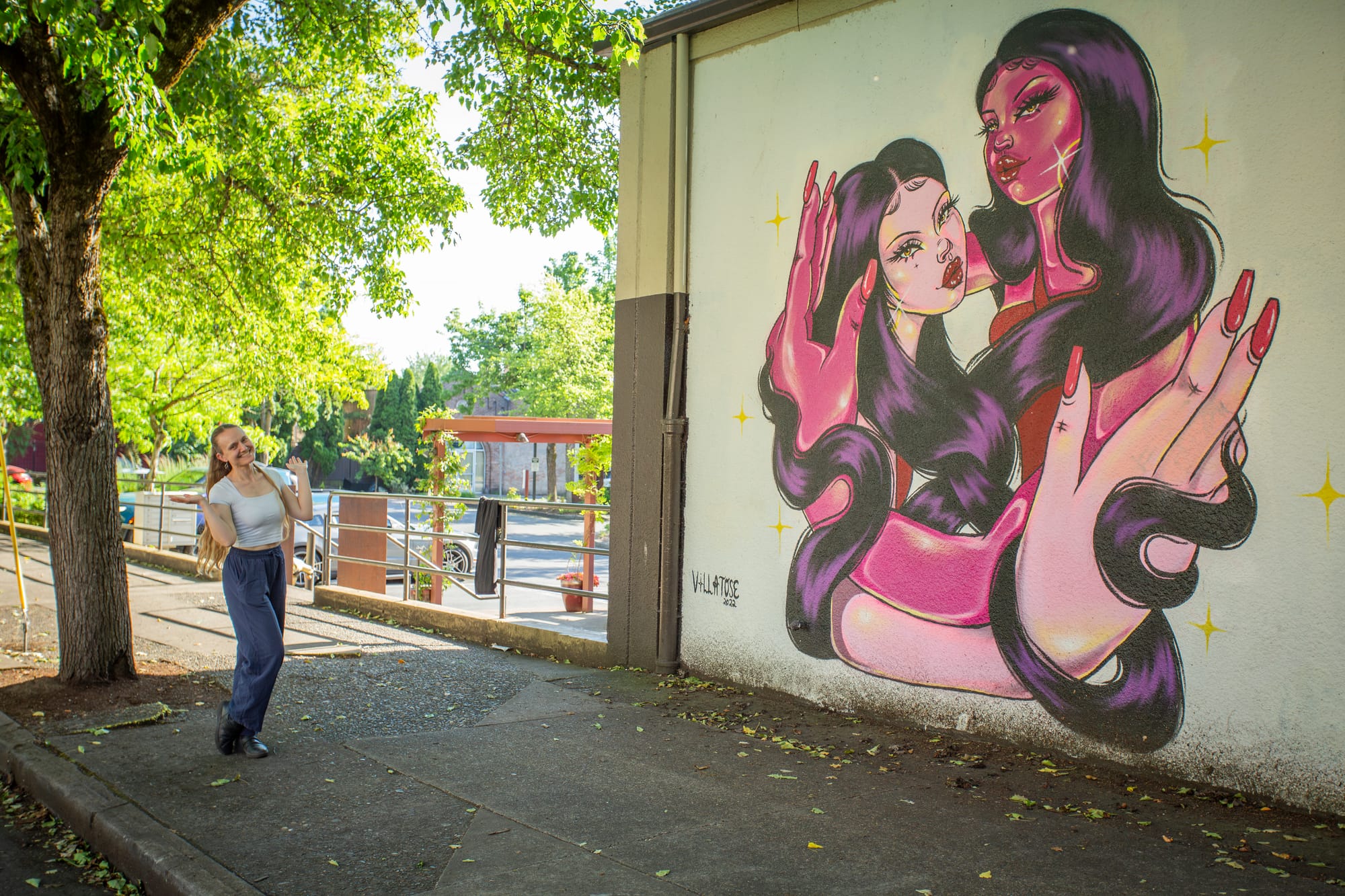 Lady posing next to a mural in downtown Portland
