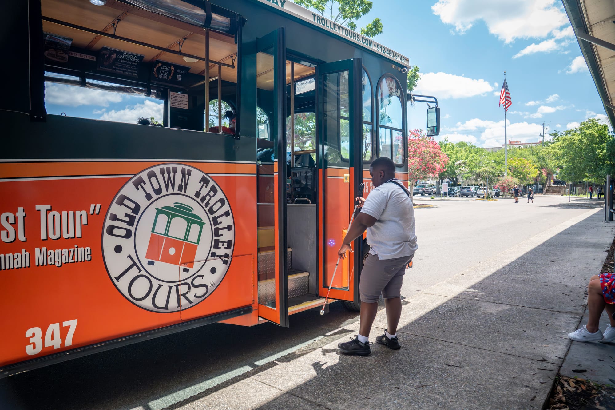 Blind person entering Old Town Trolley for a tour of Savannah