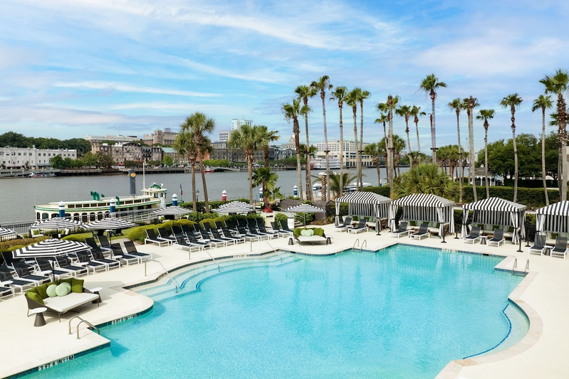 Outdoor pool and lounge with river in the background at The Westin Savannah