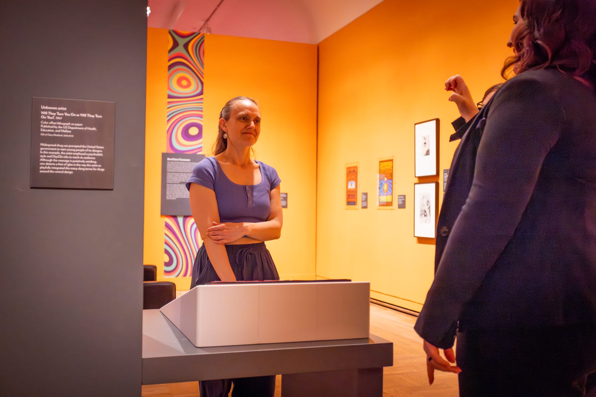 Lady doing sign language to deaf lady at Portland Art Museum