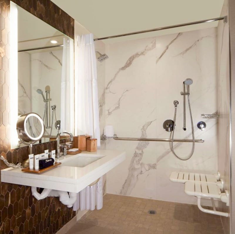 Roll-in shower, grab bars and seat at The Porter Portland hotel