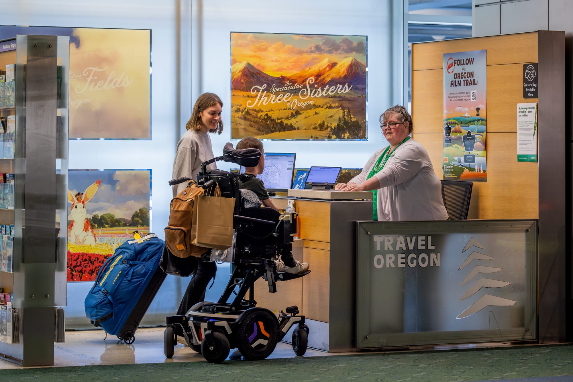 Squirmy and grubs talking to Travel Oregon Welcome Center lady in PDX