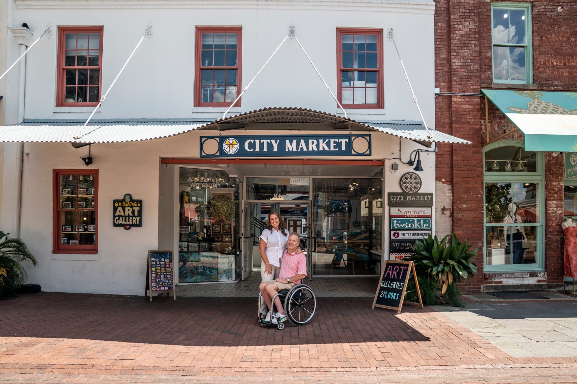 Wheelchair user and companion in front of City Market in Savannah