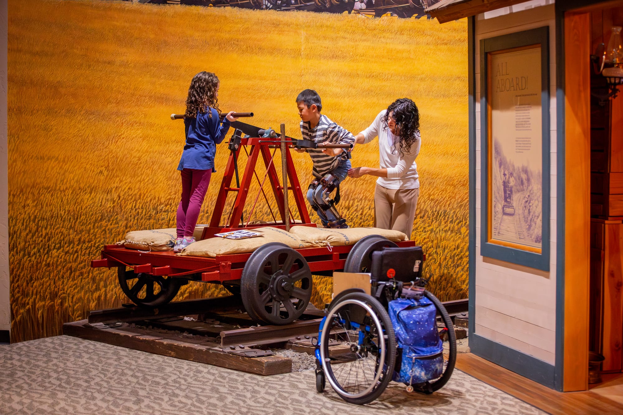 Family with wheelchair user enjoying exhibits at Columbia Gorge Discovery Center & Museum