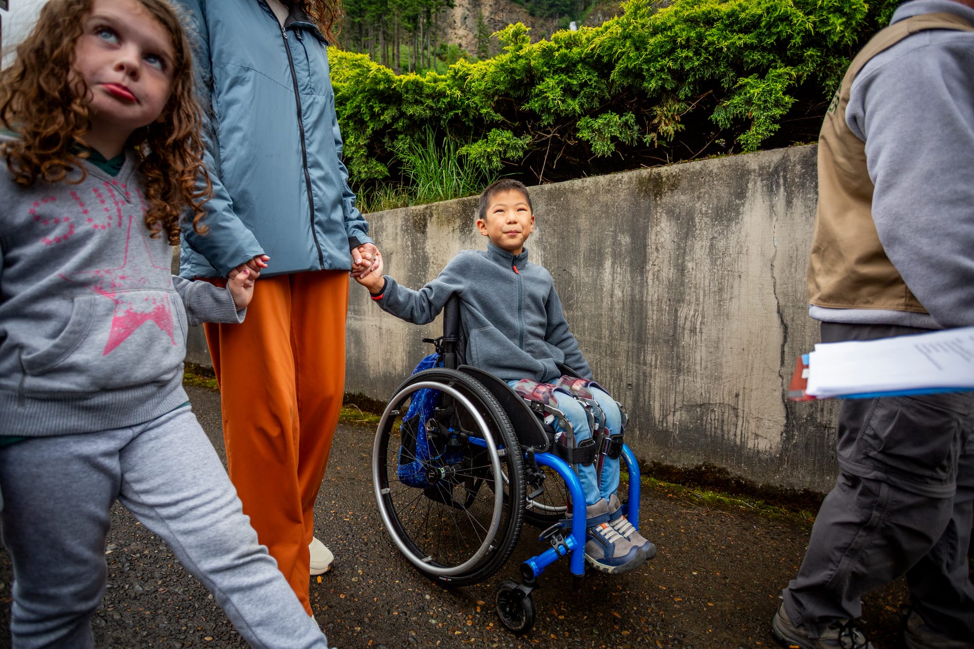 Small boy, wheelchair user, going up the path to Multonmah Falls