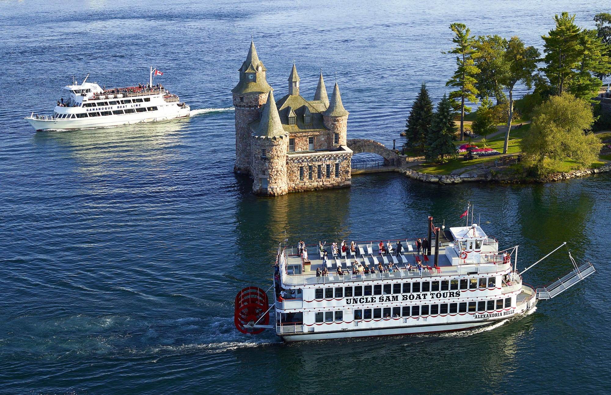 Boat tourspassing an island in 1000 Island, NY
