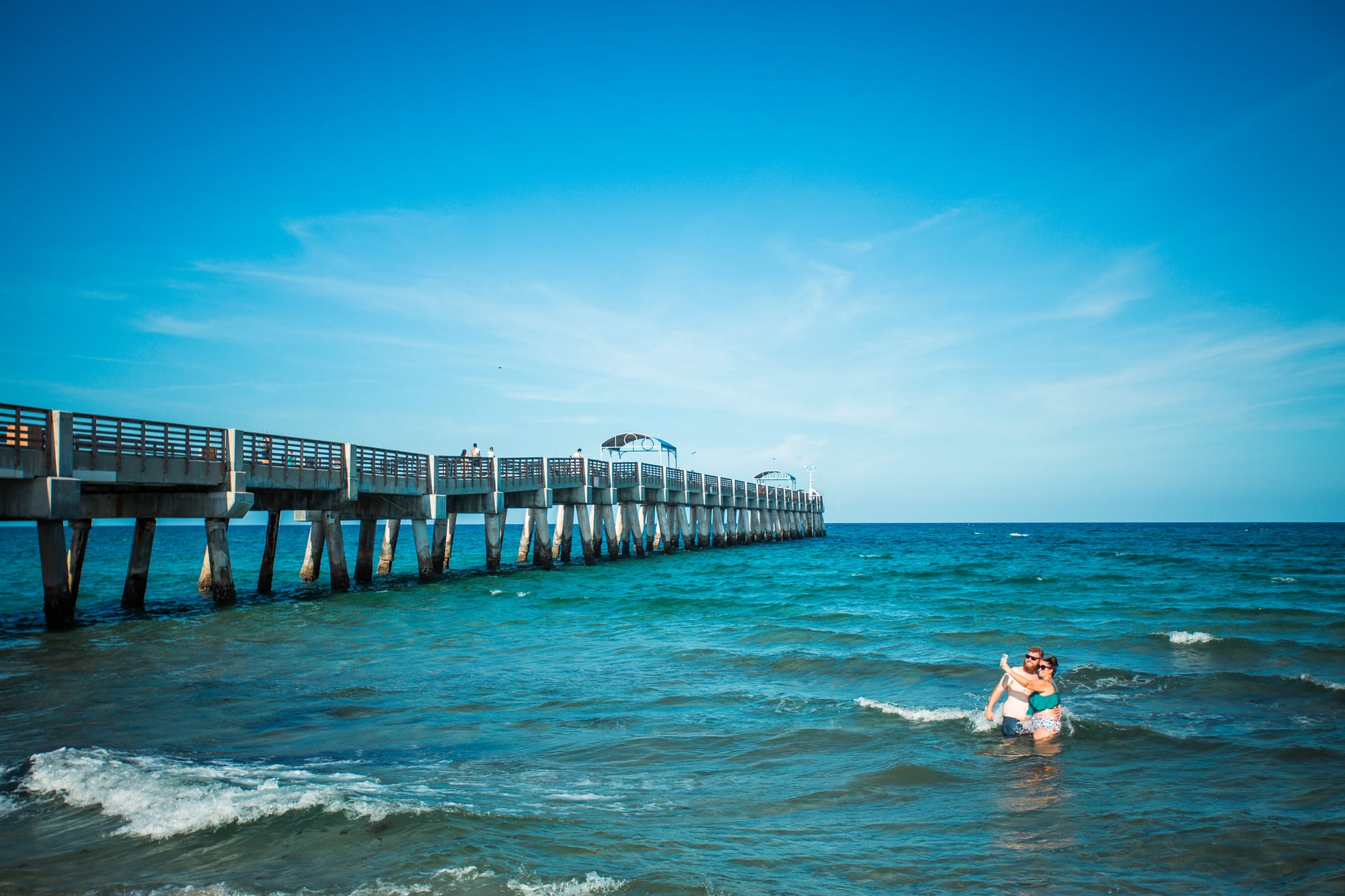 Deaf travelers in the blue waters of Juno Beach in Palm Beaches