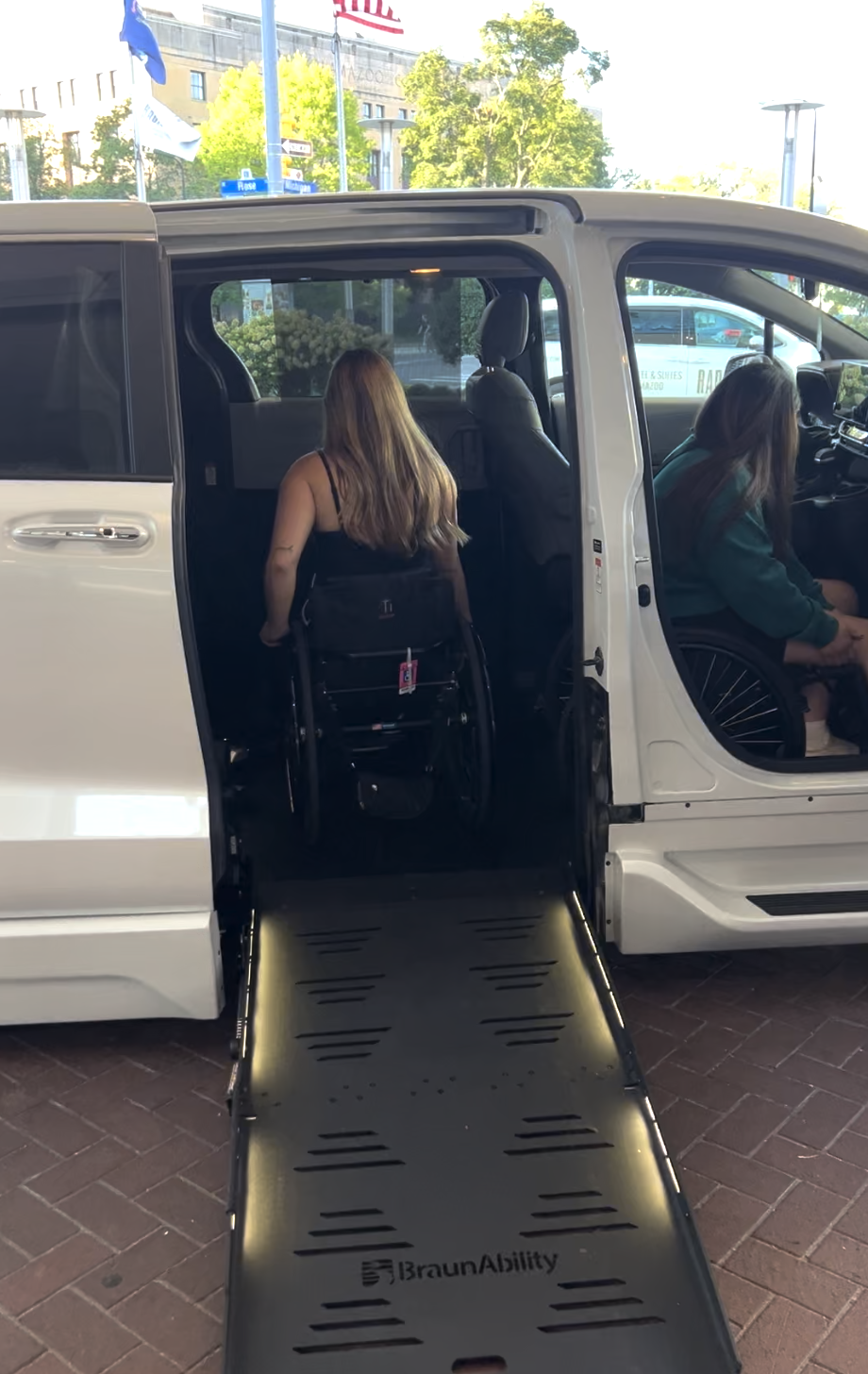 Wheelchair user entering an accessible van with a ramp in Kalamazoo