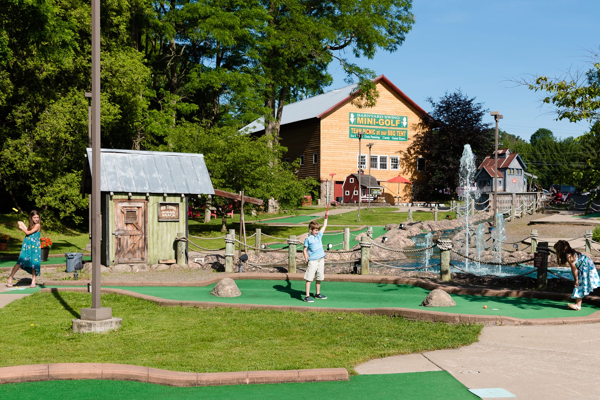 Boy enjoying mini golf at Barnyard Swing Mini Golf & Family Fun Center