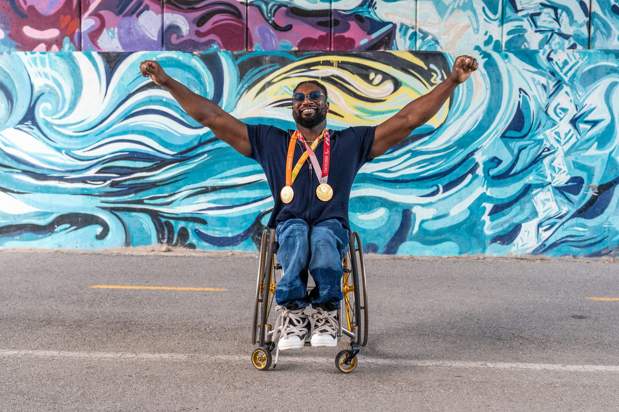 Matt Scott, Paralympian, with his two gold medals in Detroit