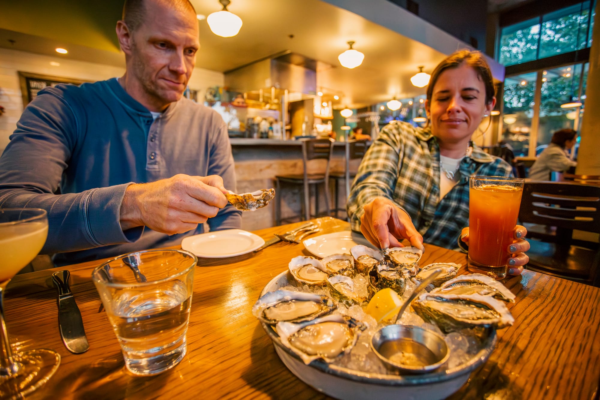 Brad and Maggie trying oysters at Taylor Shellfish Oyster Bar in Seattle