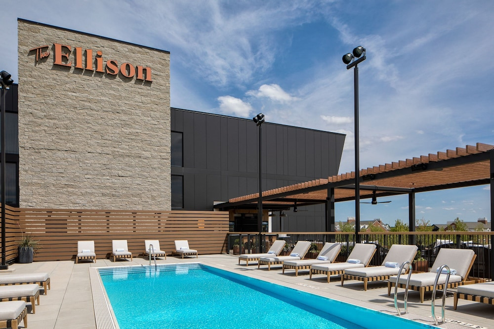 Outdoor pool and lounge chairs at The Ellison, Oklahoma City, a Tribute Portfolio Hotel