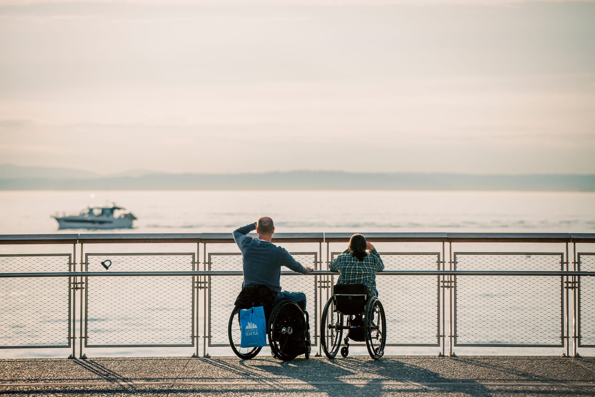 Two wheelchair users overlooking the Seattle Waterfront