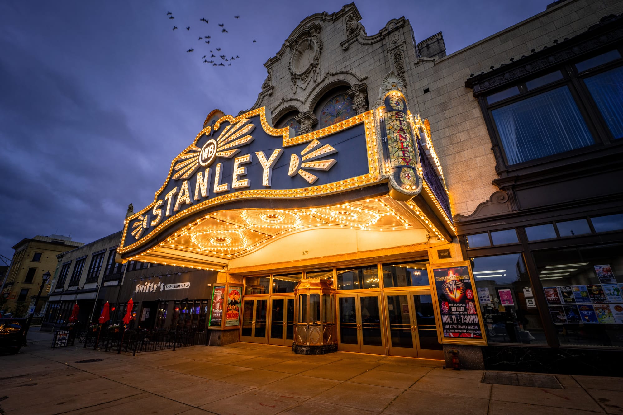 Lit up exterior sign of Stanley Theatre in Utica, NY