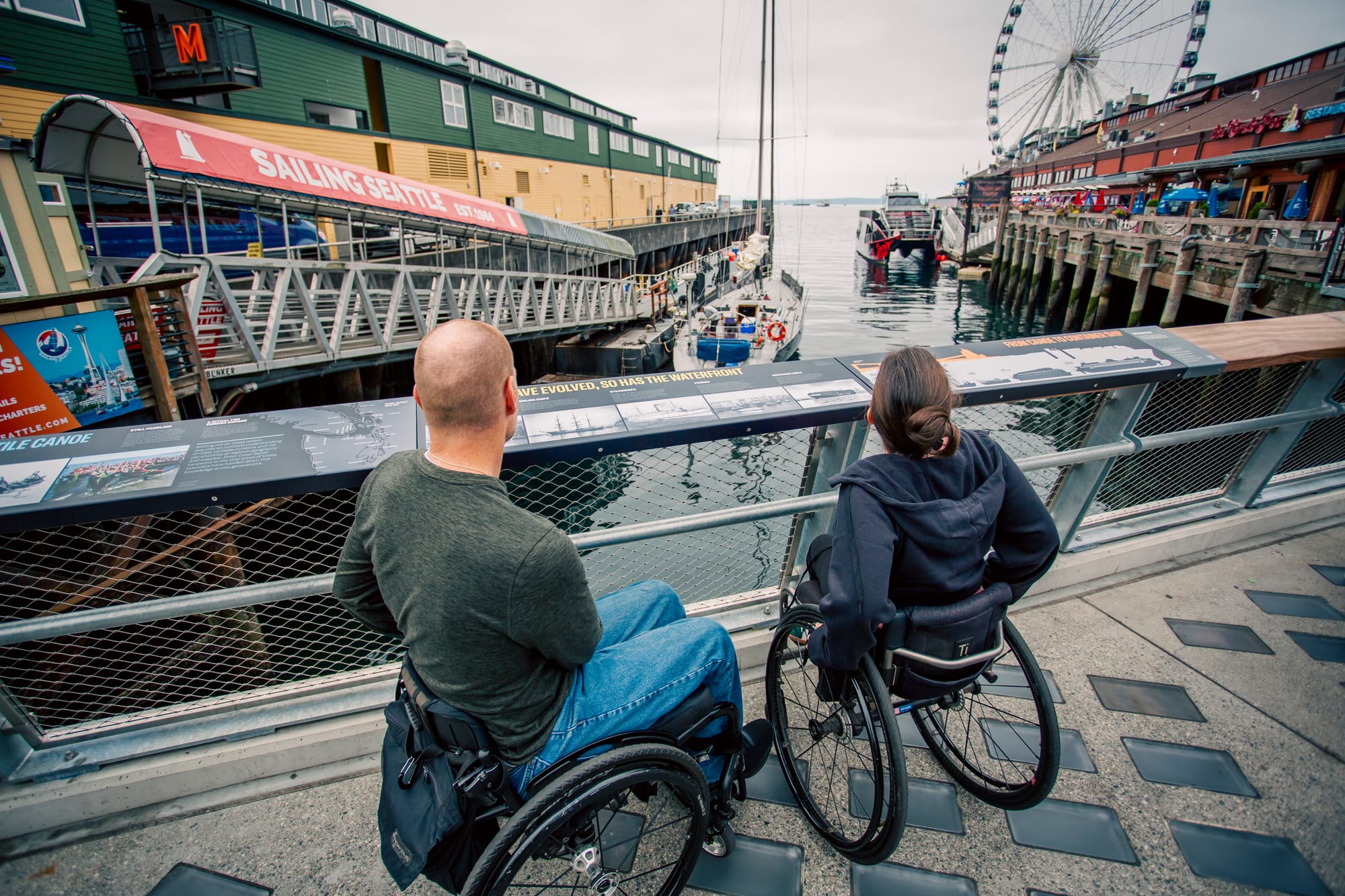 Maggie and Brad, two wheelchair users, overlooking the water in Seattle