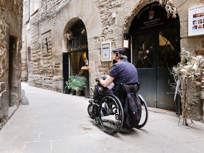 Wheelchair user exploring the Gothic Quarter in Barcelona