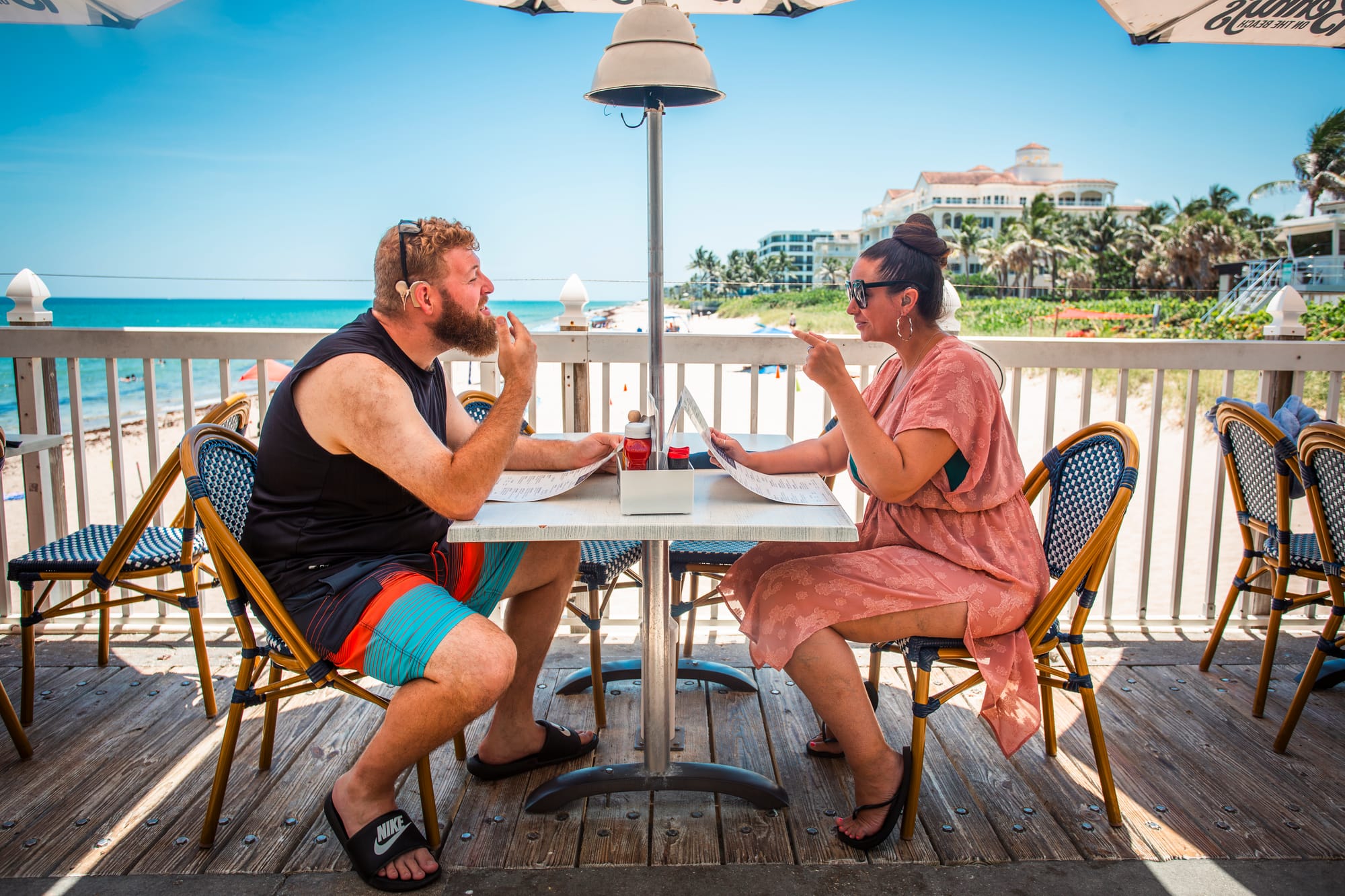 Deaf couple about to order at Benny's On The Beach on Palm Beaches, Florida