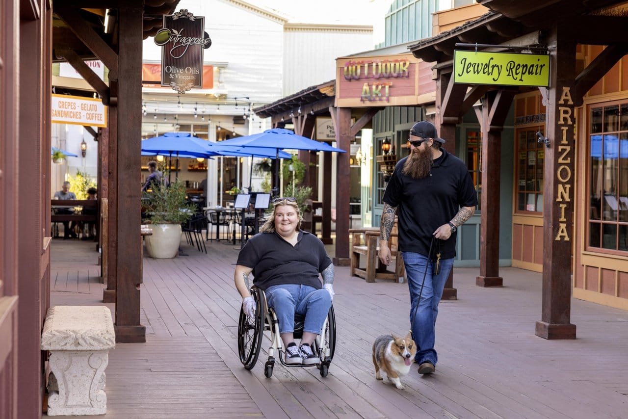 Wheelchair user, companion, and dog walking Old Town Scottsdale