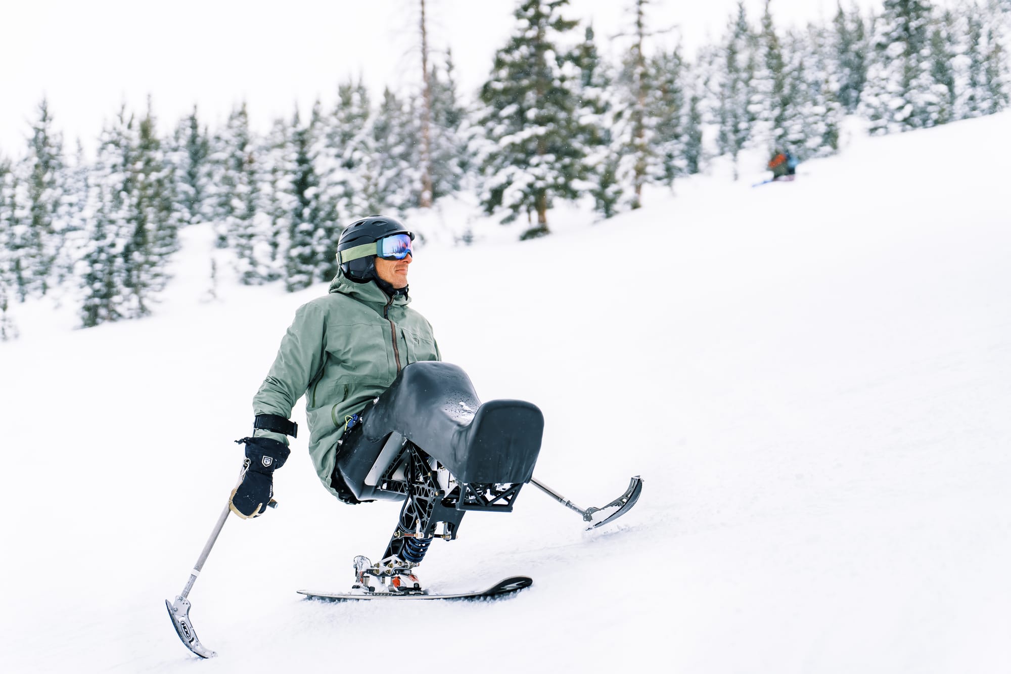 Adaptive skier going down the mountain