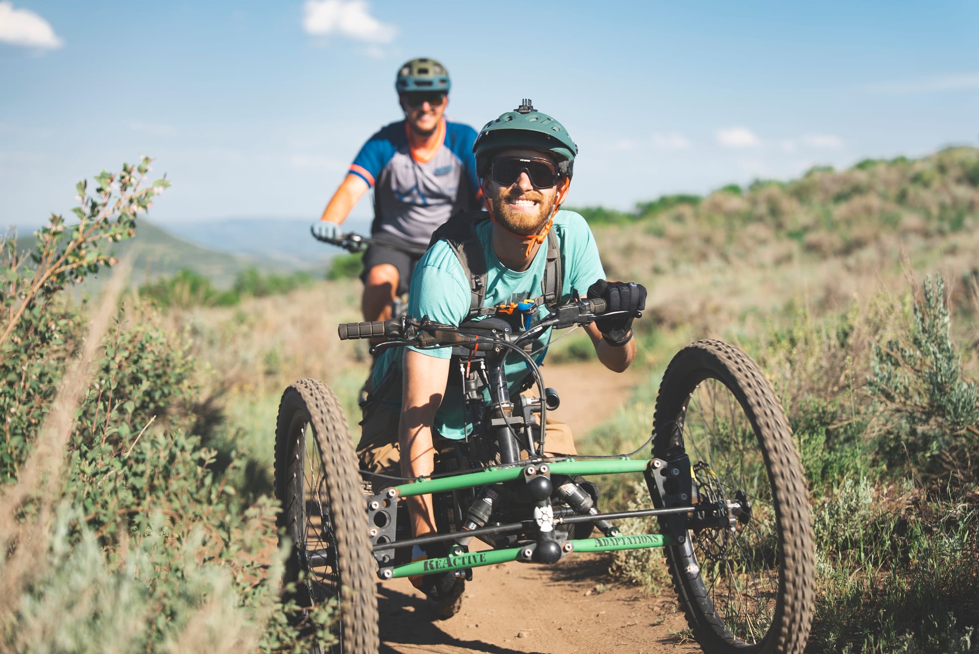 Man smiling while adaptive hand-biking on Park City trails