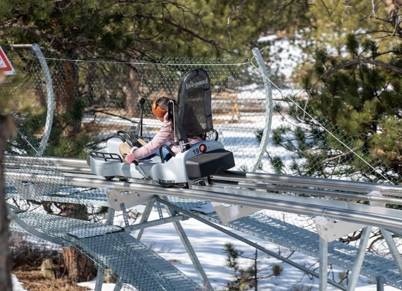 Girl riding down the Mustang Mountain Coaster in Estes Park