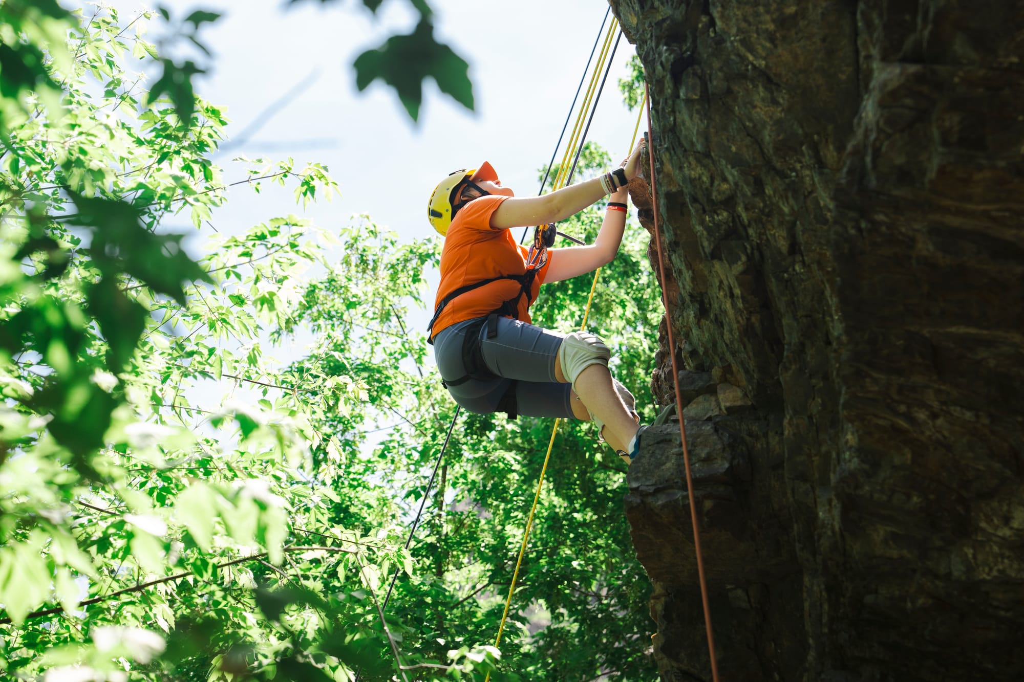 Woman climbing with harnesses