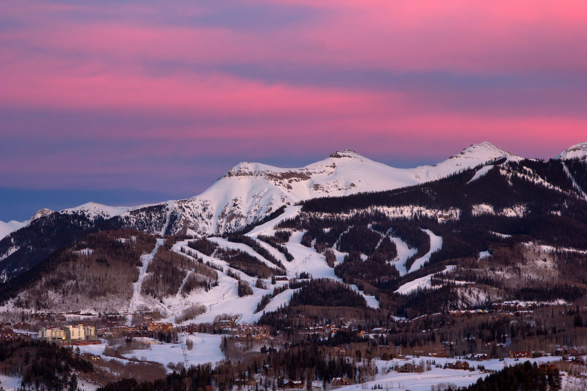 Aerial view of ski slopes with mountain in the background