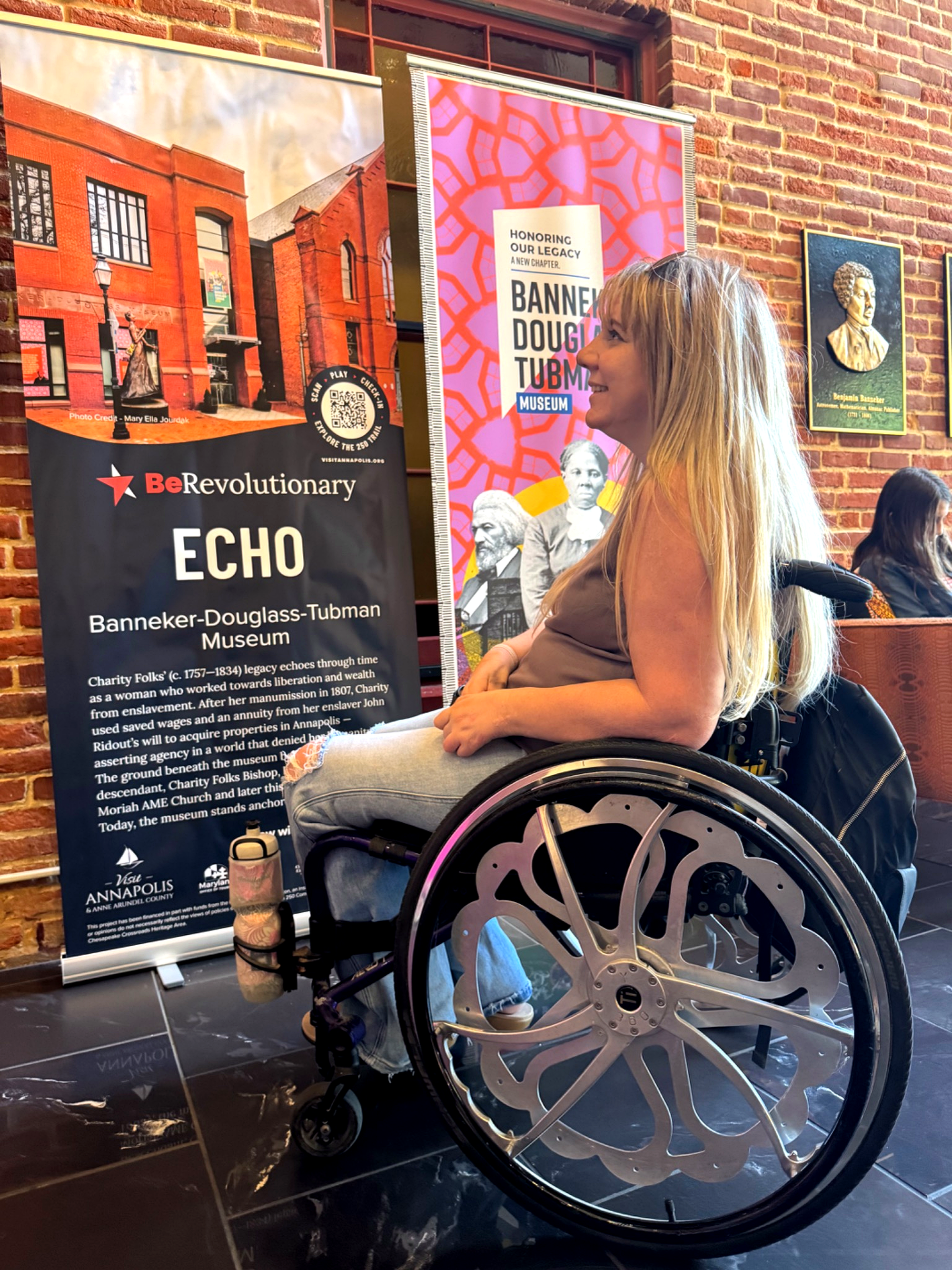 Wheelchair user learning and reading exhibits at Banneker-Douglass-Tubman Museum