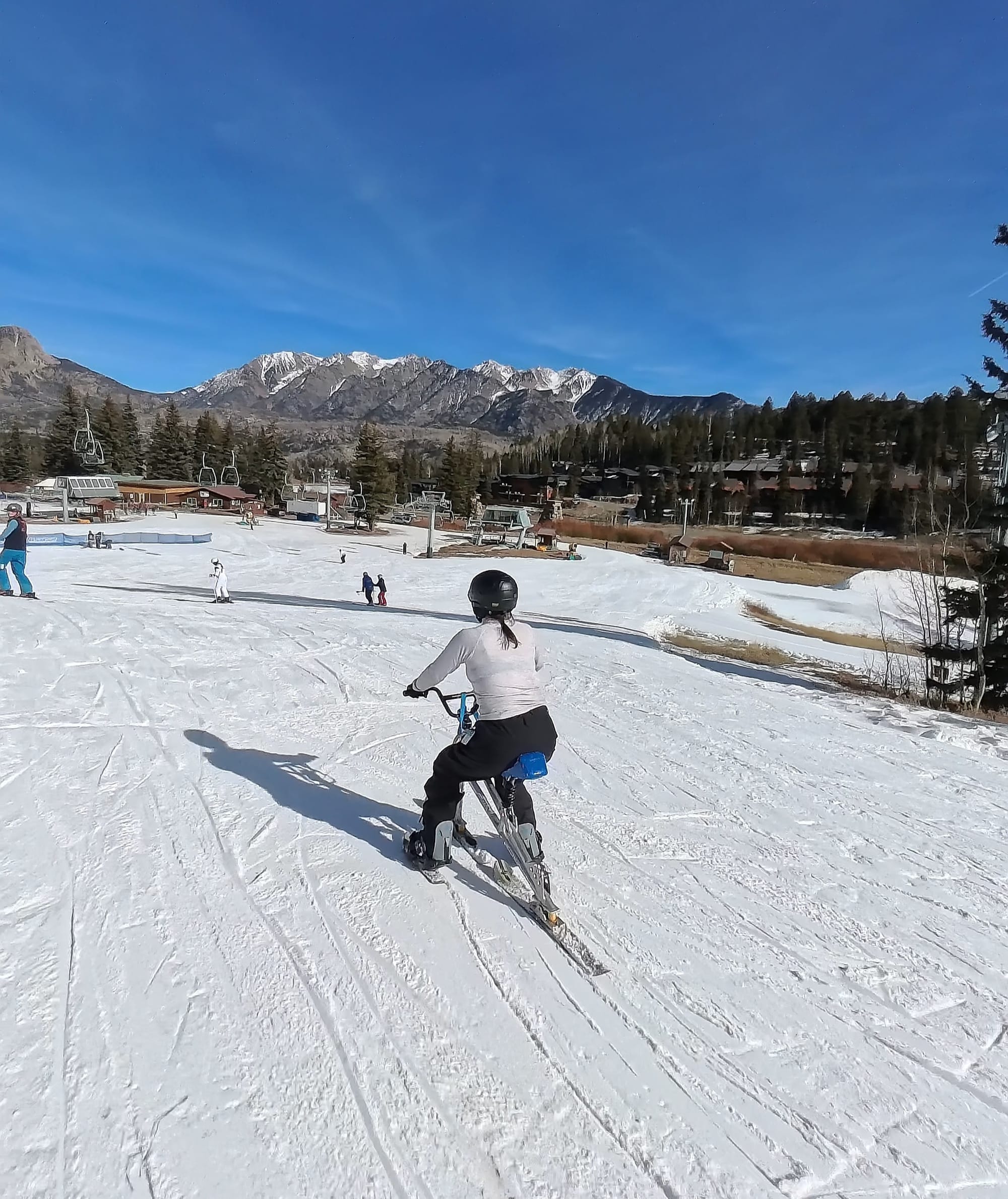 Amputee going down the slopes on an adaptive ski bike in Durango, Colorado