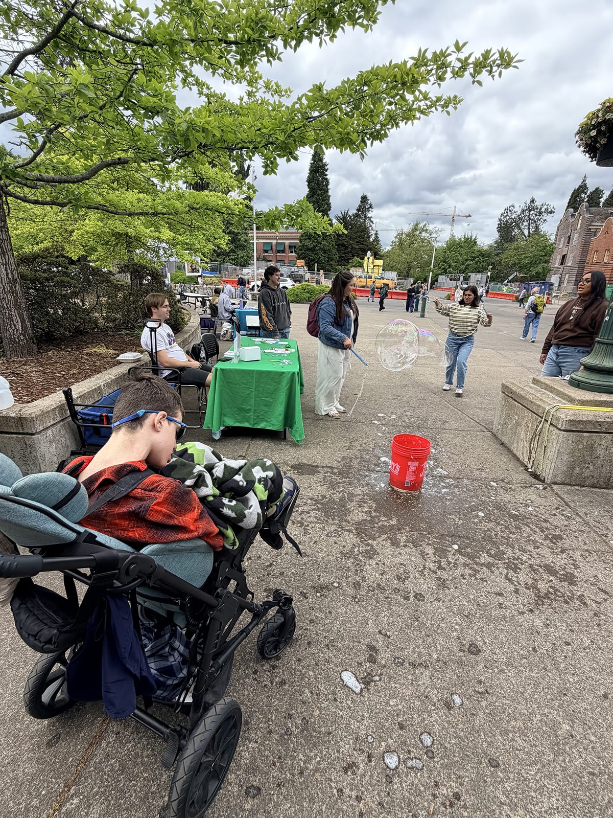 Wheelchair user enjoying the bubbles at University of Oregon