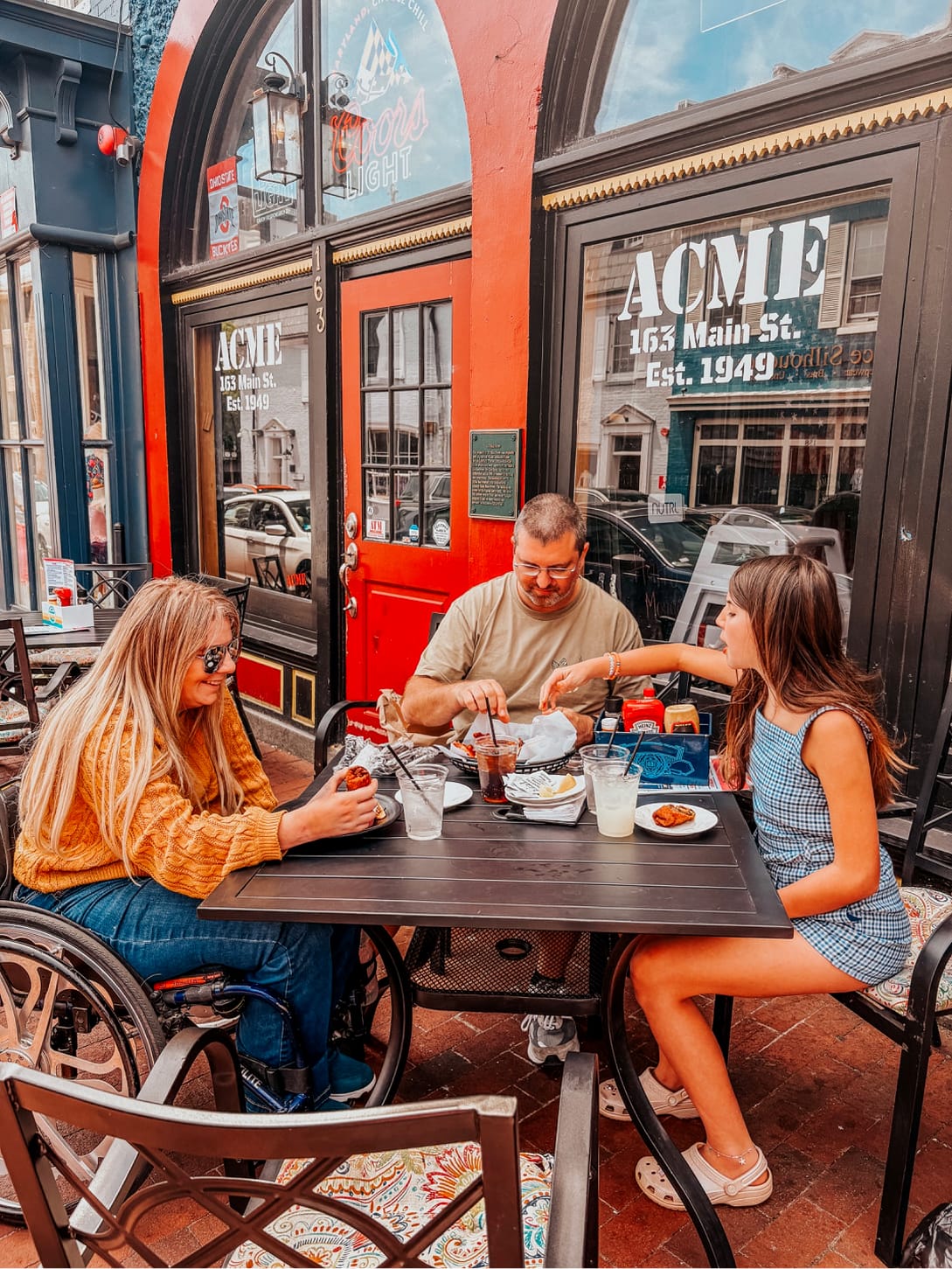 Wheelchair user and family eating on outdoor patio in Annapolis