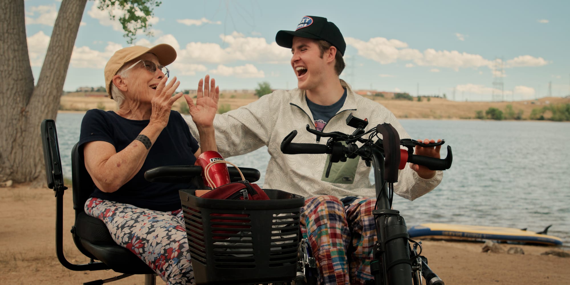 Two wheelchair users laughing during their travels