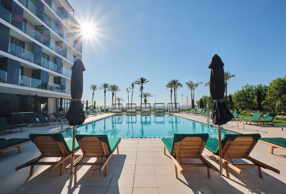Outdoor pool and lounge area at ESTIMAR Marina Farnals