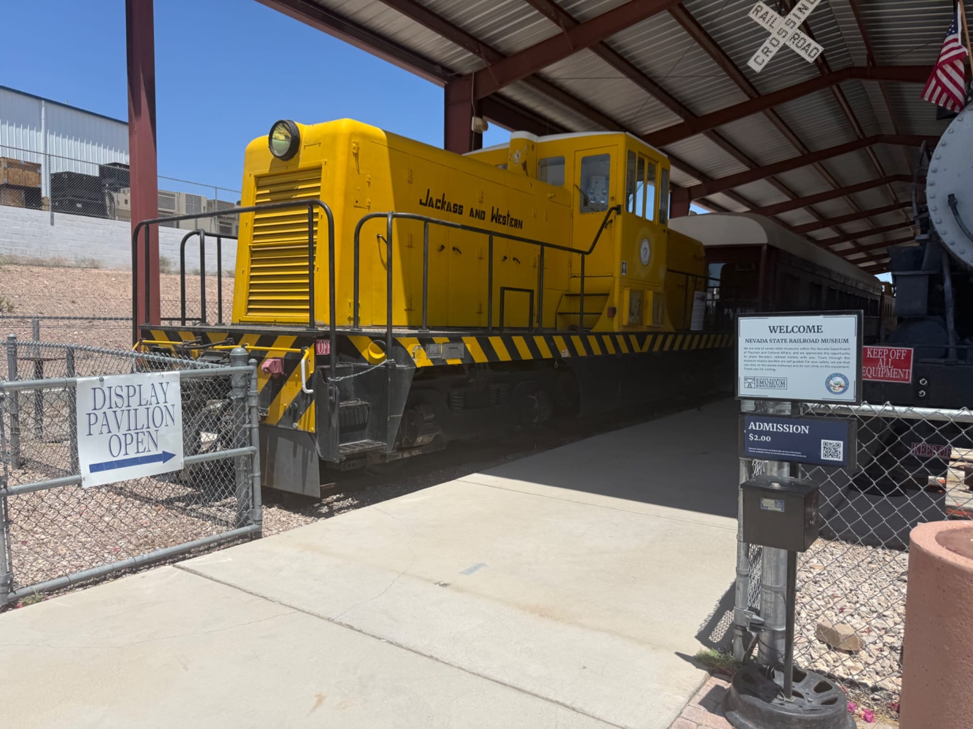 Yellow train and signs at Nevada State Railroad Museum in Boulder City, Nevada