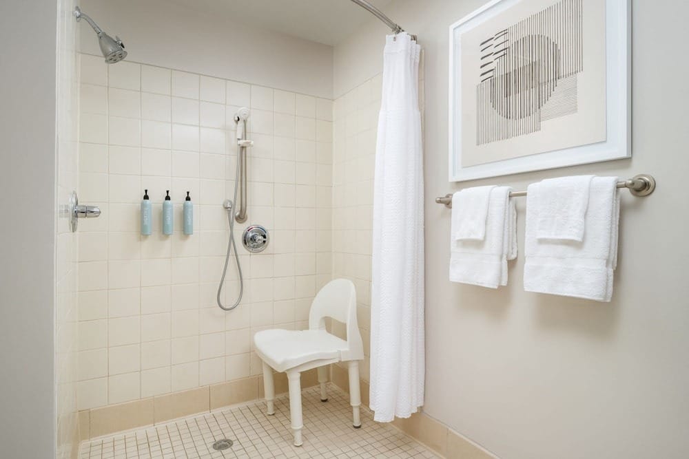 Roll-in shower and chair at Courtyard by Marriott Kingston
