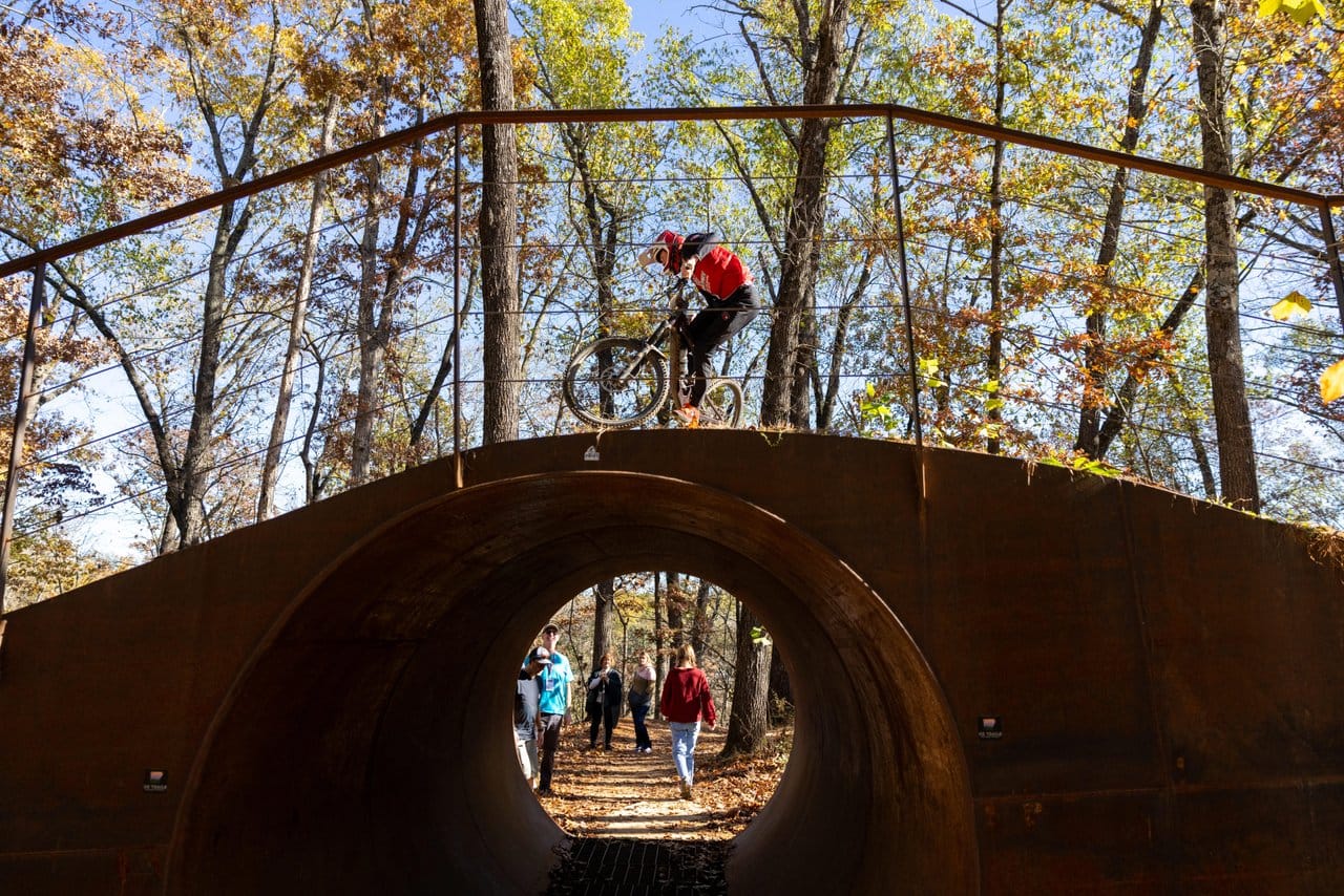 Biker going across a bridge at Slaughter Pen Mountain Bike Park