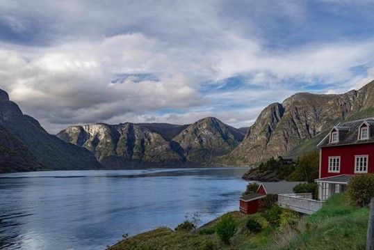 Norway fjords with red house on the hill