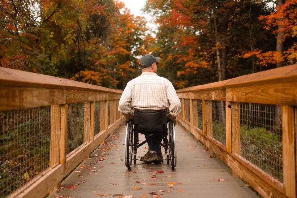 Wheelchair user across a boardwalk at Carpenter Falls, Finger Lakes
