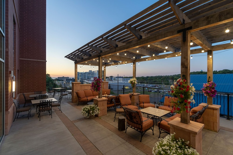 Outdoor patio, chairs, and lights at Staybridge Suites Marquette by IHG