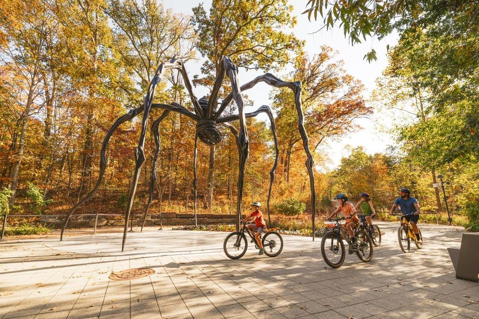 Bike riders through Crystal Bridges Museum of American Art