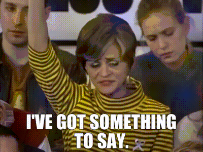 A woman raising her hand. "I've got something to say."