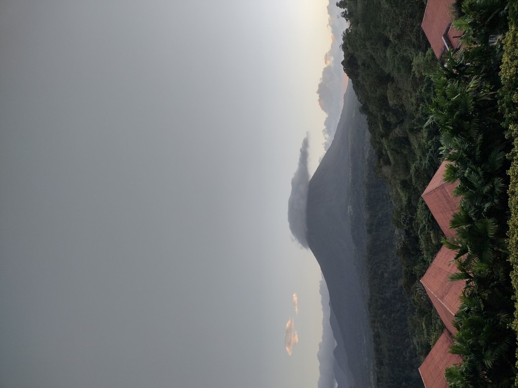 The volano in the distance at dusk, with a cloud covering the top of it. Aww, man. 