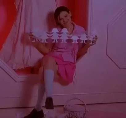 Clea Duvall's character holding a train of paper girls