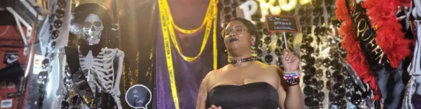 Me at goth prom, wearing a strapless dress holding up a sign saying "I too am strange and unusual."