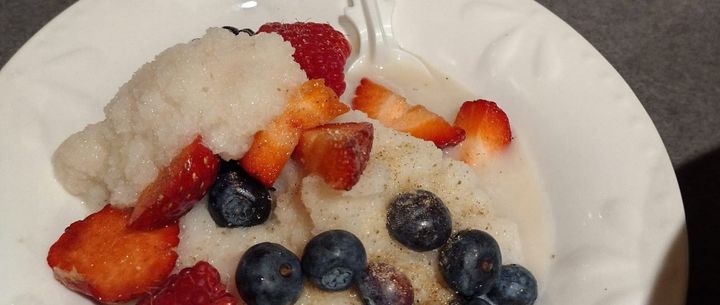 Snow cream, with berries and cardomom sprinkled on top.