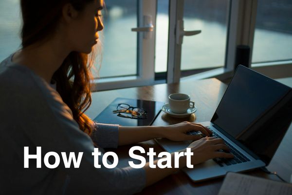A woman sits at a computer and works on her clinical research consulting business. 