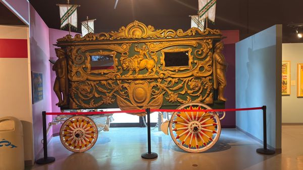 Ornately carved and painted historic circus wagon on display inside Circus World in Baraboo, Wisconsin.